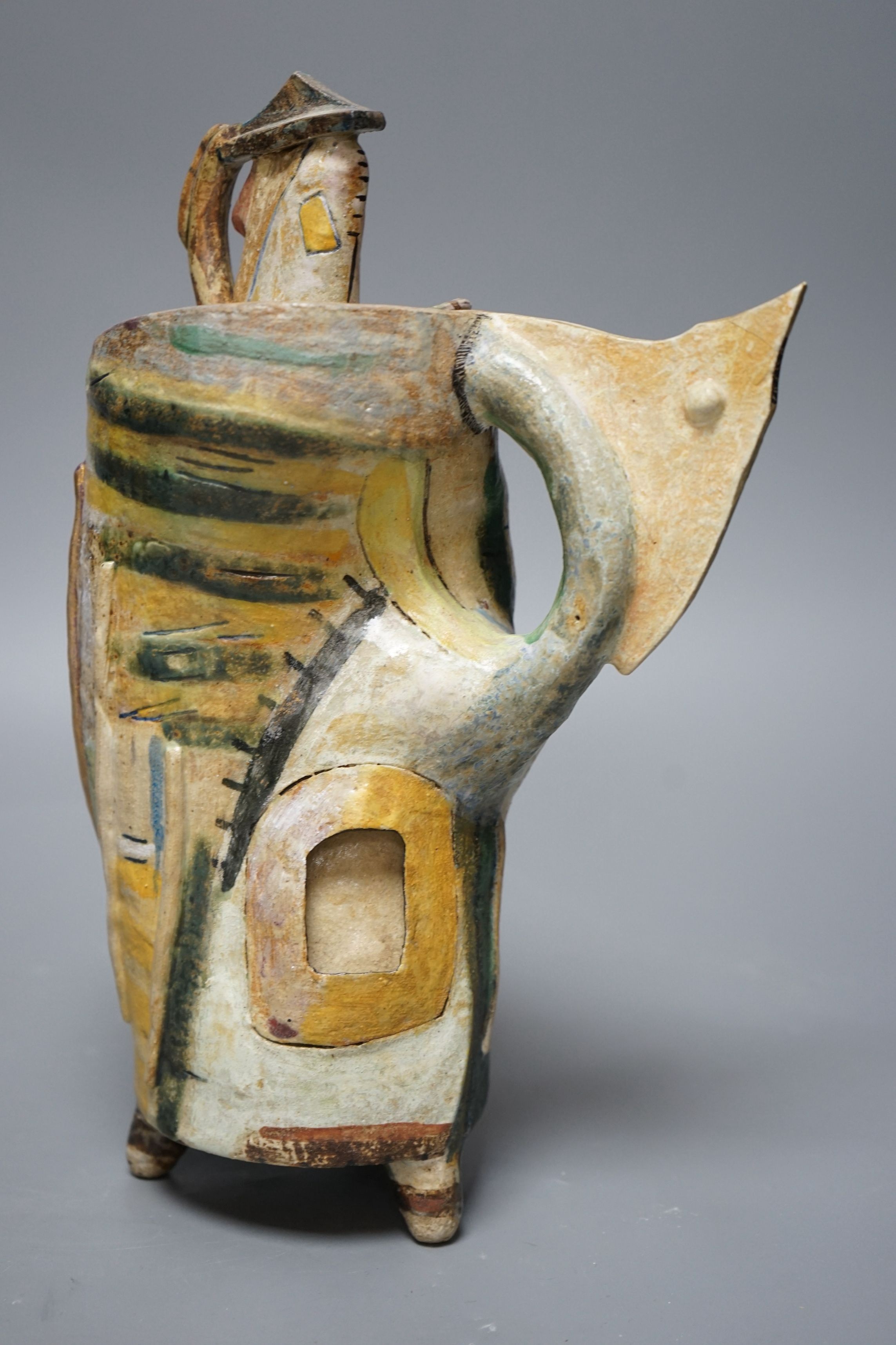 Angus Suttie (1946-1993), an abstract polychrome glazed stoneware jug and cover on tripod base, inscribed ‘Angus 86’, 29cm tall (Damage)